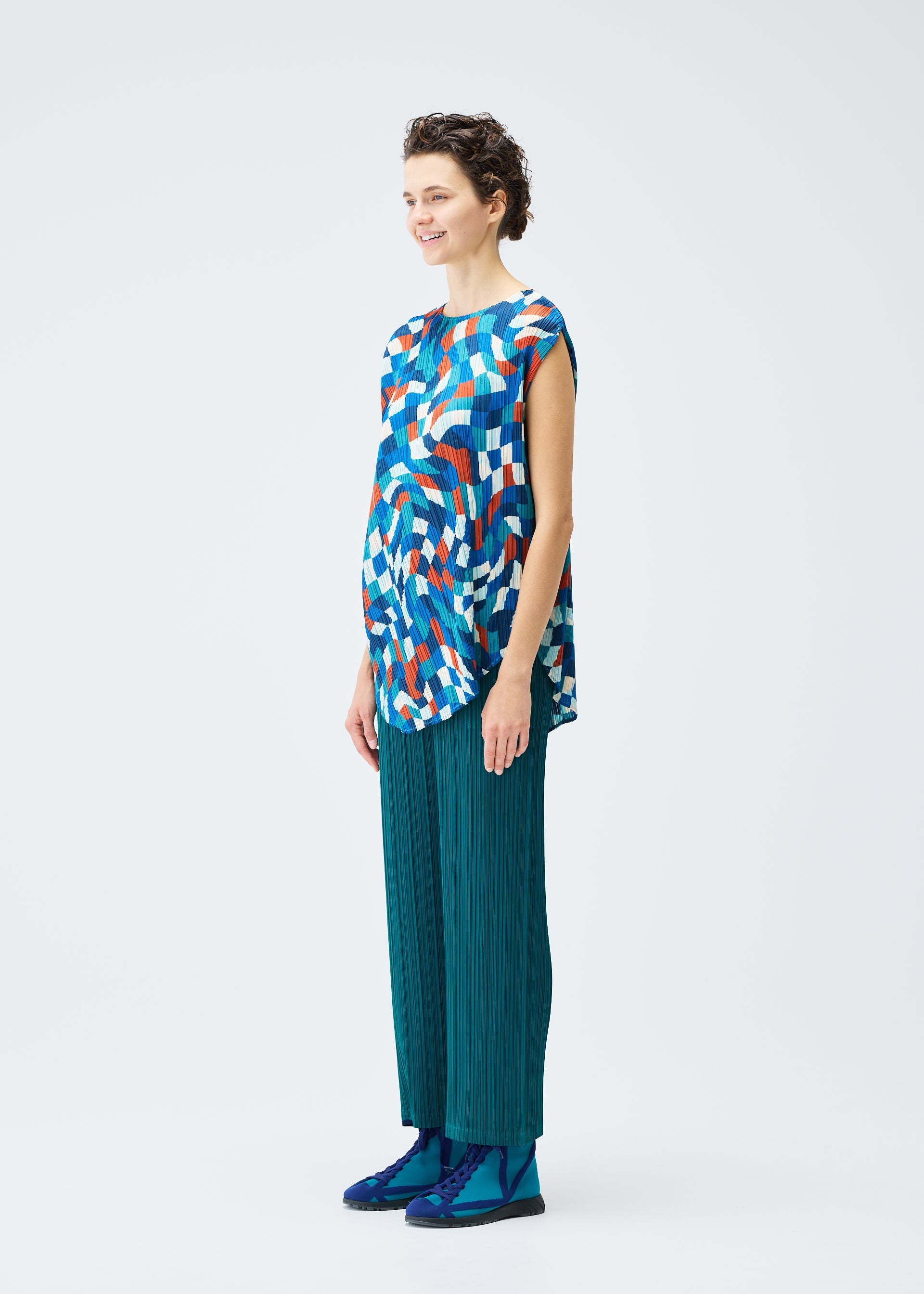 A model wears the PLEATS PLEASE ISSEY MIYAKE DANCING SQUARE top.