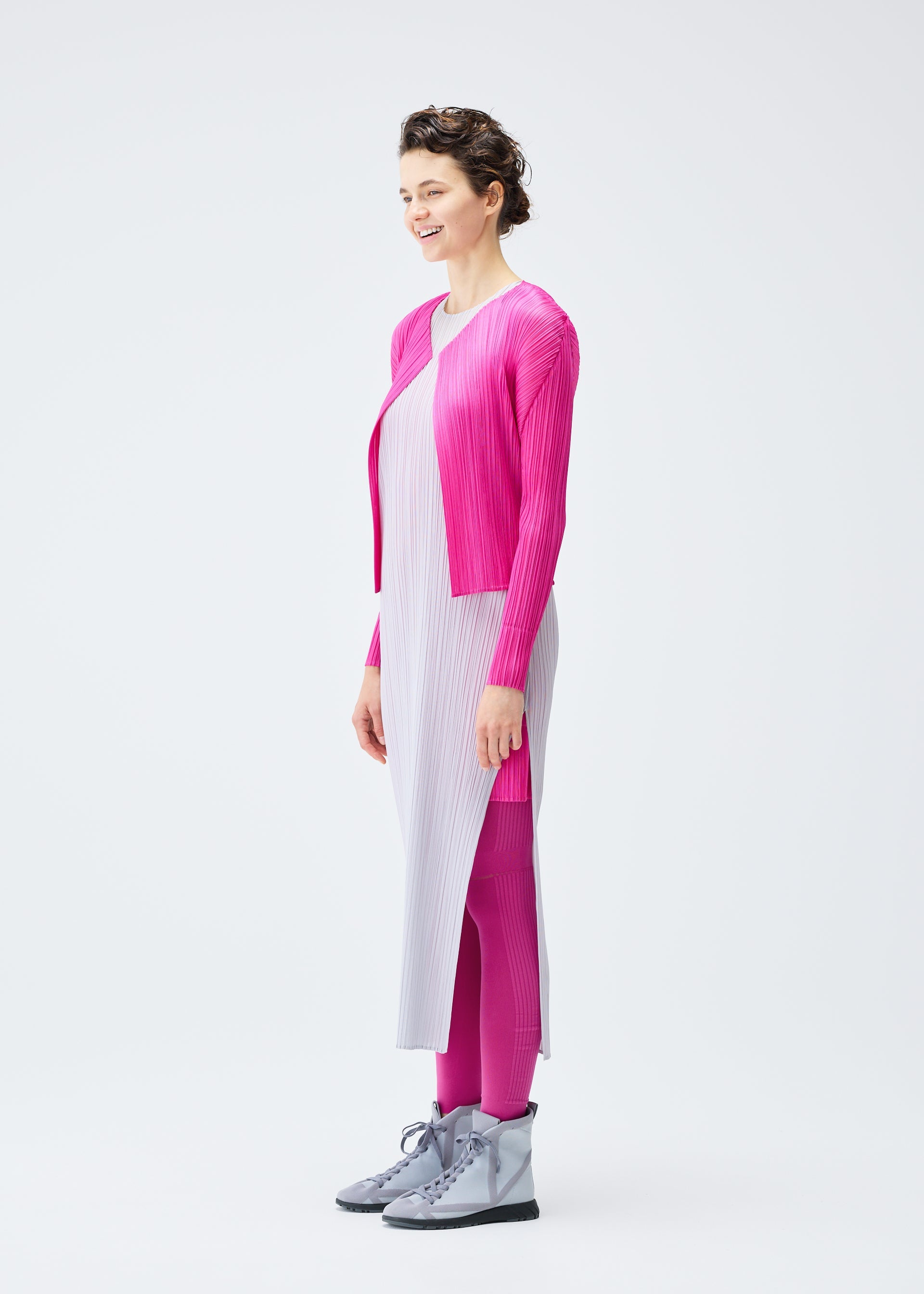 A model wears the PLEATS PLEASE ISSEY MIYAKE LUCID PLEATS cardigan.