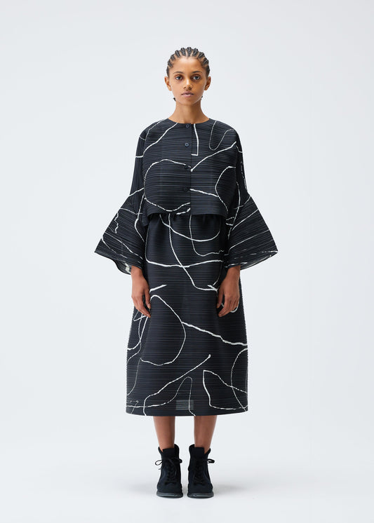 A model wears the PLEATS PLEASE ISSEY MIYAKE PAUSE cardigan.