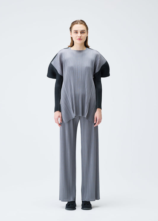 A model wears the PLEATS PLEASE ISSEY MIYAKE SQUARE tunic.
