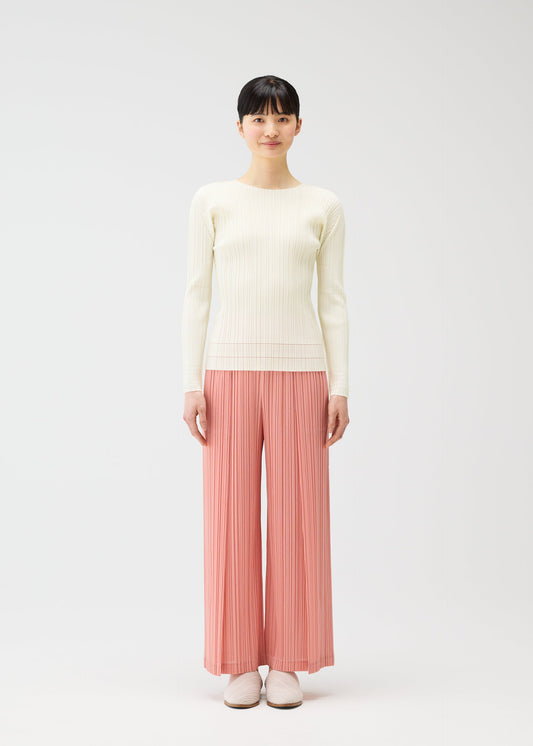 A model wears the PLEATS PLEASE ISSEY MIYAKE RAMIE PLEATS trousers.