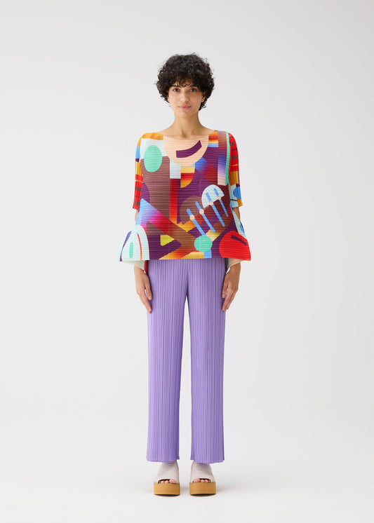 A model wears the PLEATS PLEASE ISSEY MIYAKE PLAYGROUND shirt.