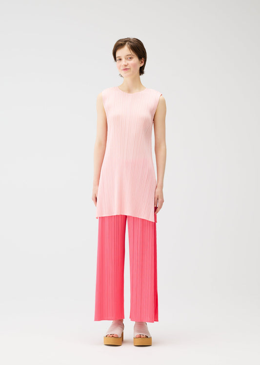 A model wears the PLEATS PLEASE ISSEY MIYAKE MONTHLY COLORS MARCH dress.