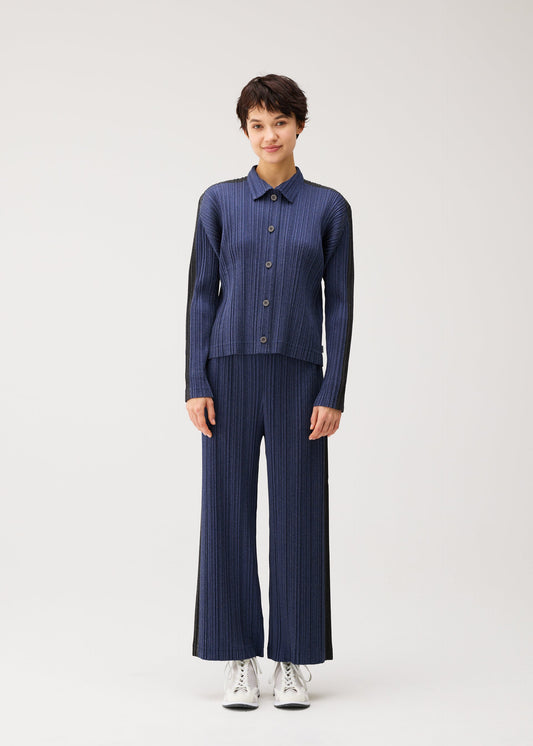 A model wears the PLEATS PLEASE ISSEY MIYAKE COTTON DENIM cotton-denim-jacket-dark-green.