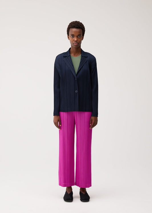 A model wears the PLEATS PLEASE ISSEY MIYAKE PLEATS JACKET pleats-jacket-jacket-charcoal.