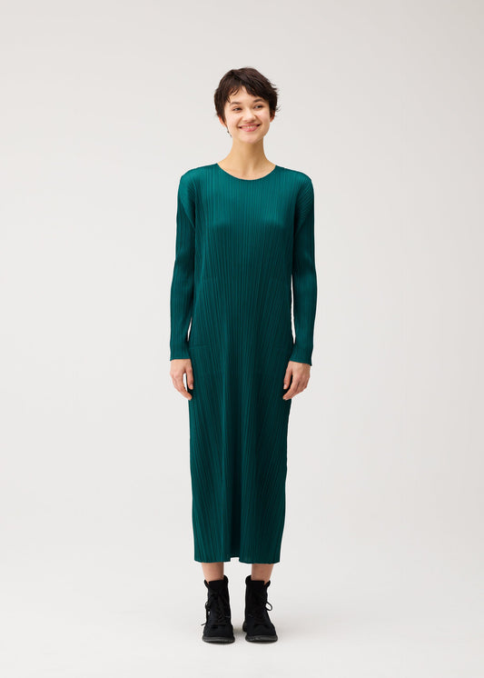 A model wears the PLEATS PLEASE ISSEY MIYAKE MONTHLY COLORS : OCTOBER monthly-colors-october-midi-dress-ash-beige.