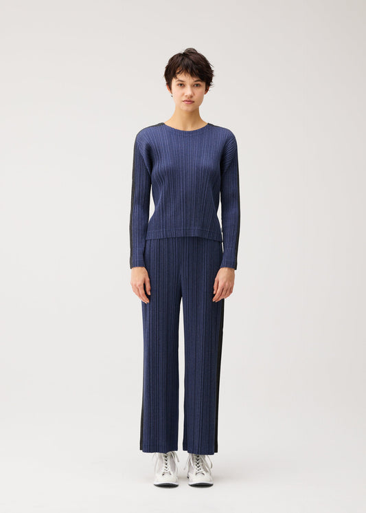 A model wears the PLEATS PLEASE ISSEY MIYAKE COTTON DENIM cotton-denim-top-dark-green.