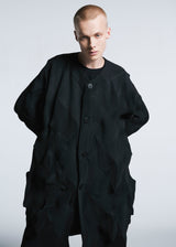 A model wears the A-POC ABLE ISSEY MIYAKE TYPE O 017 coat.