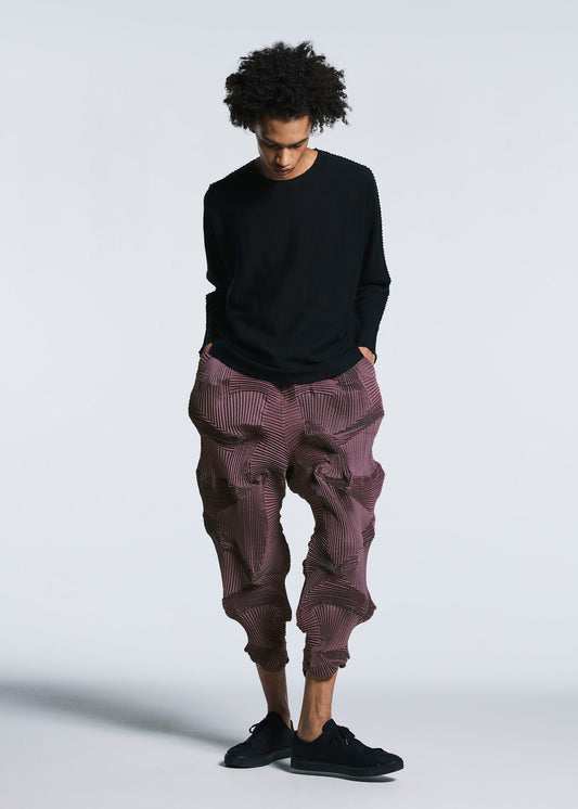 A model wears the A-POC ABLE ISSEY MIYAKE TYPE O 003 1 trousers.