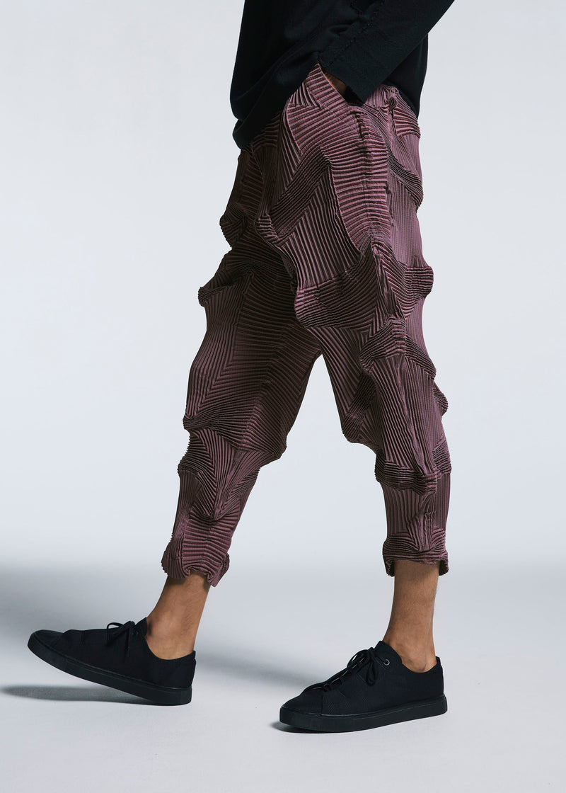 A model wears the A-POC ABLE ISSEY MIYAKE TYPE O 003 1 trousers.