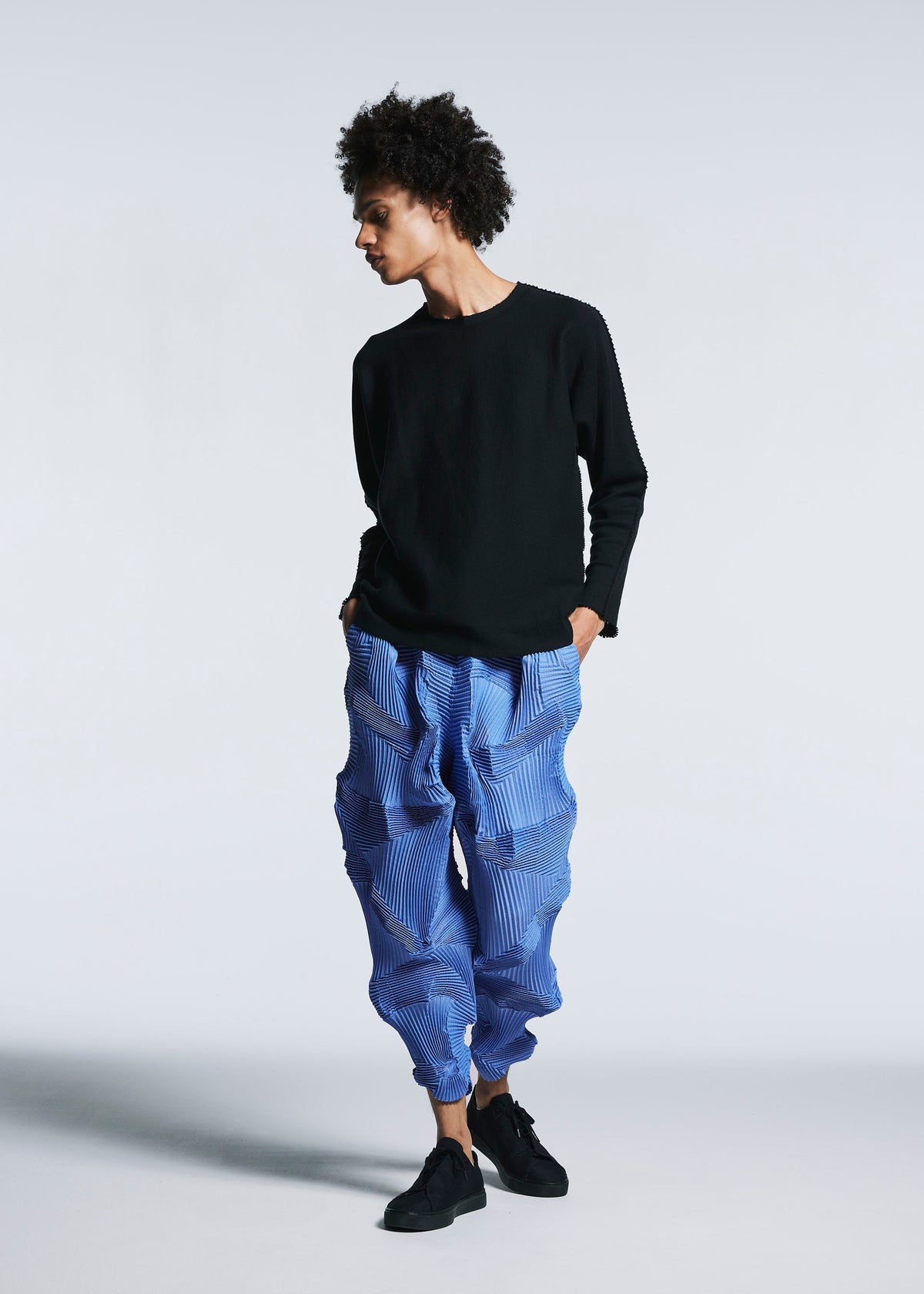 A model wears the A-POC ABLE ISSEY MIYAKE TYPE O 003 2 trousers.