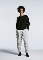 A model wears the A-POC ABLE ISSEY MIYAKE TYPE O 016 trousers.