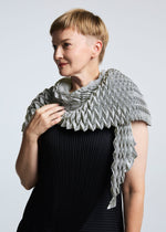 A model wears the A-POC ABLE ISSEY MIYAKE TYPE O STOLE stole.