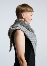 A model wears the A-POC ABLE ISSEY MIYAKE TYPE O STOLE stole.