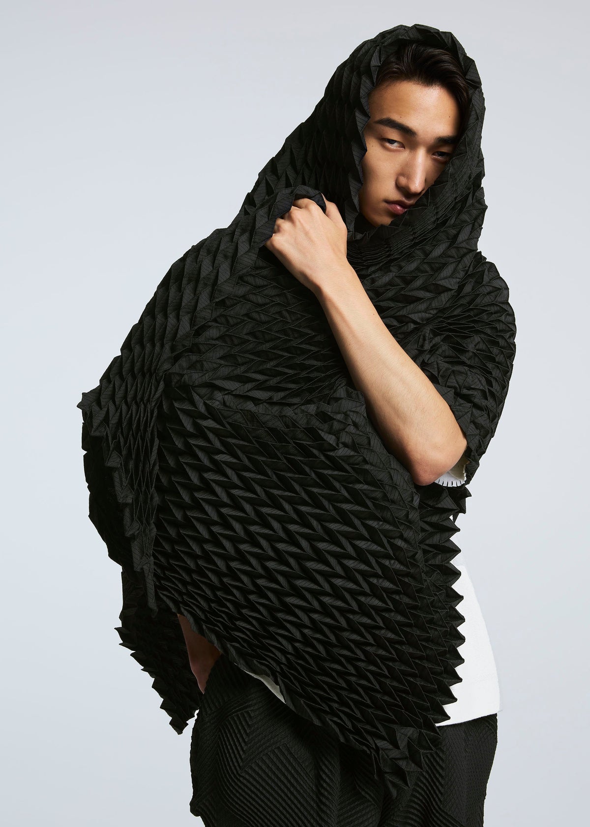A model wears the A-POC ABLE ISSEY MIYAKE TYPE O STOLE stole.