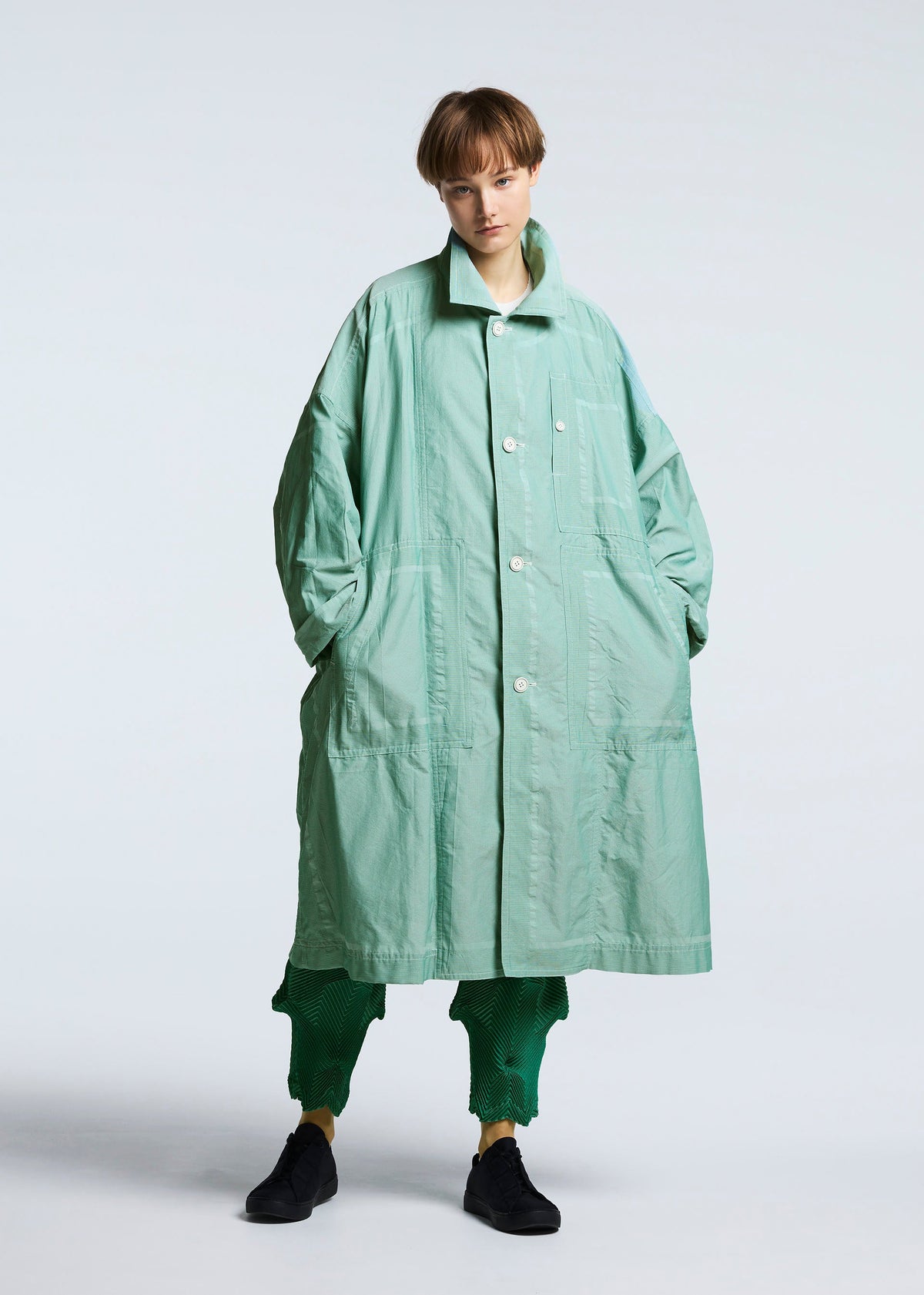A model wears the A-POC ABLE ISSEY MIYAKE TYPE U 002 coat.