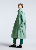 A model wears the A-POC ABLE ISSEY MIYAKE TYPE U 002 coat.