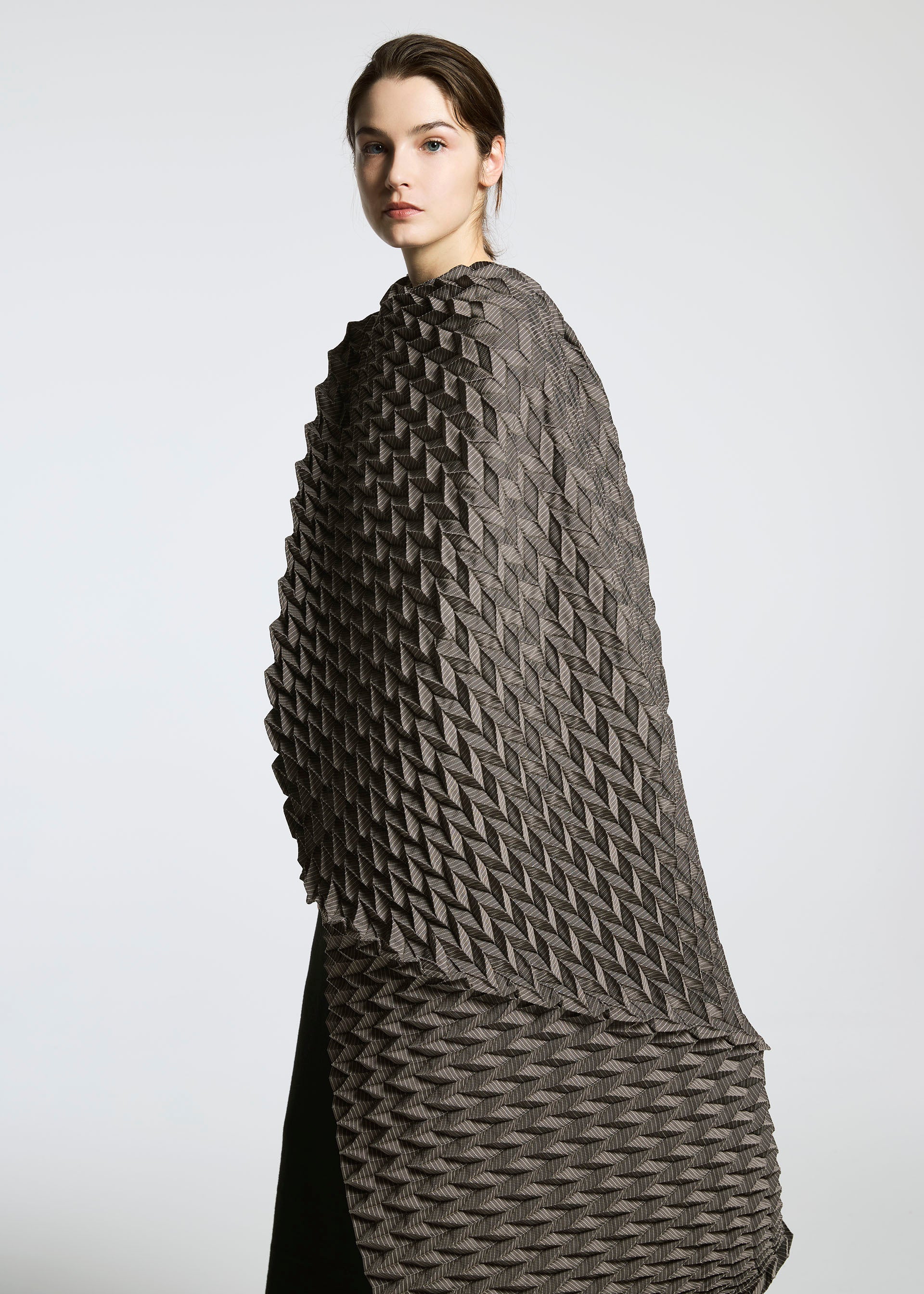 A model wears the A-POC ABLE ISSEY MIYAKE TYPE O STOLE accessories.
