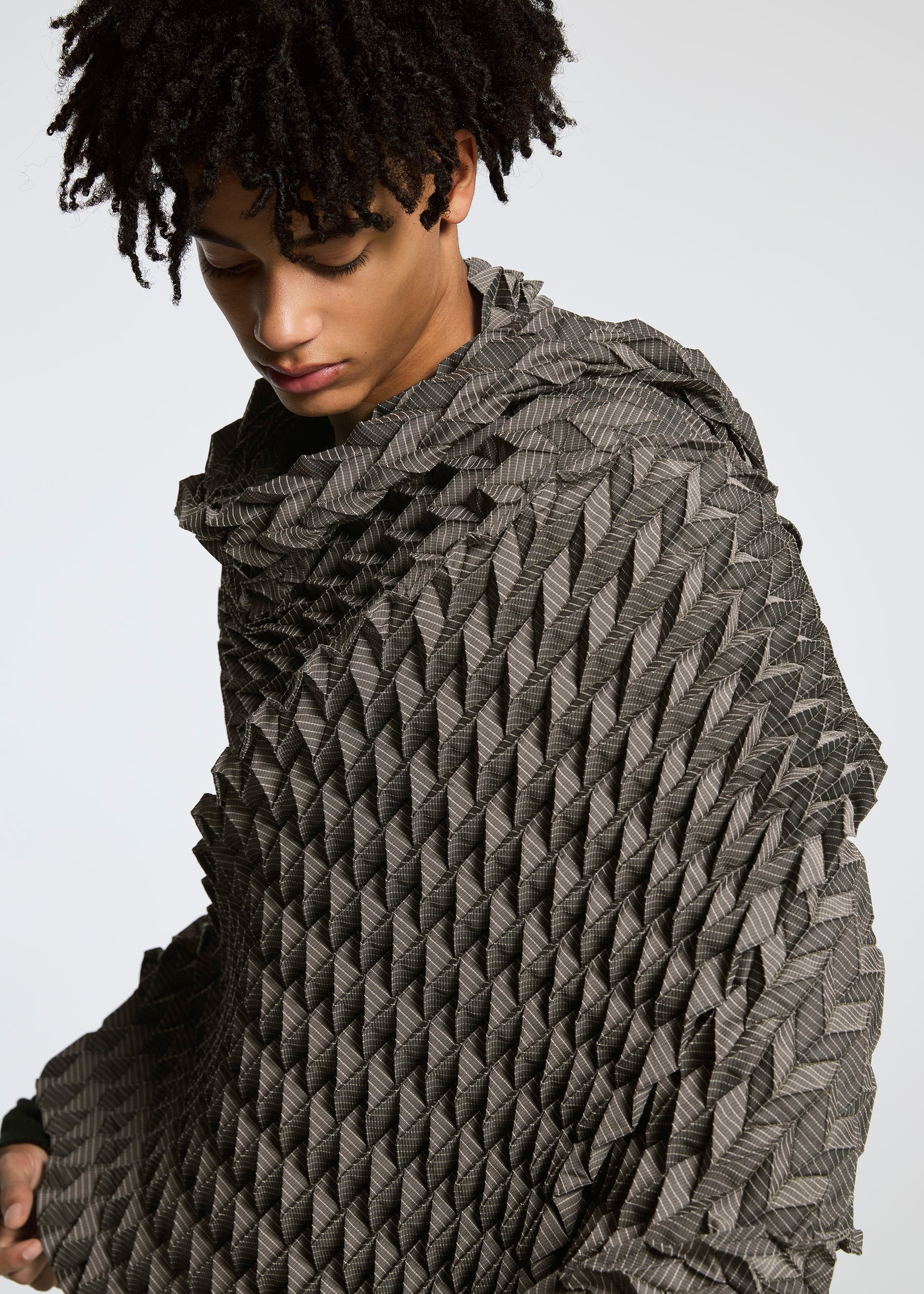 A model wears the A-POC ABLE ISSEY MIYAKE TYPE O STOLE accessories.