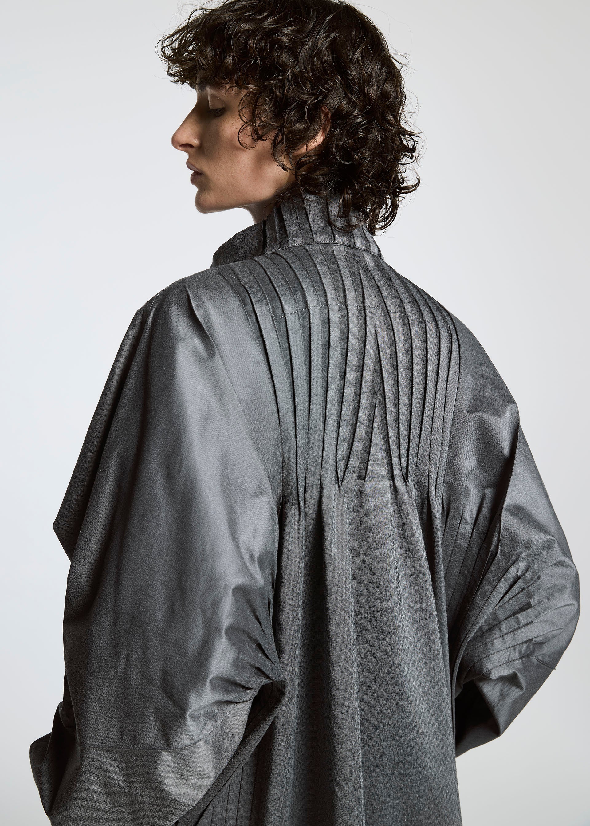 A model wears the A-POC ABLE ISSEY MIYAKE TYPE S 001 1 coat.