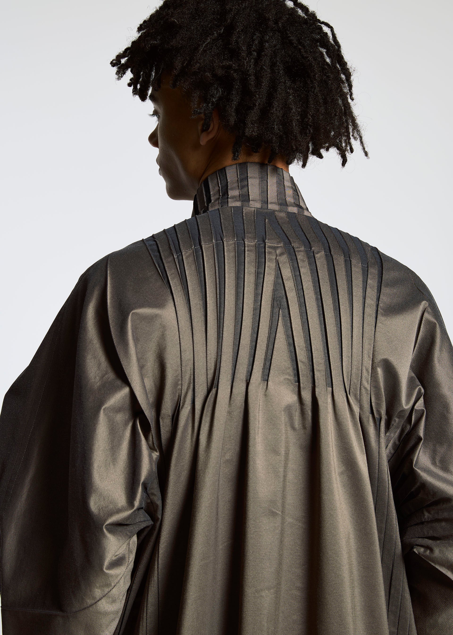 A model wears the A-POC ABLE ISSEY MIYAKE TYPE S 001 1 coat.