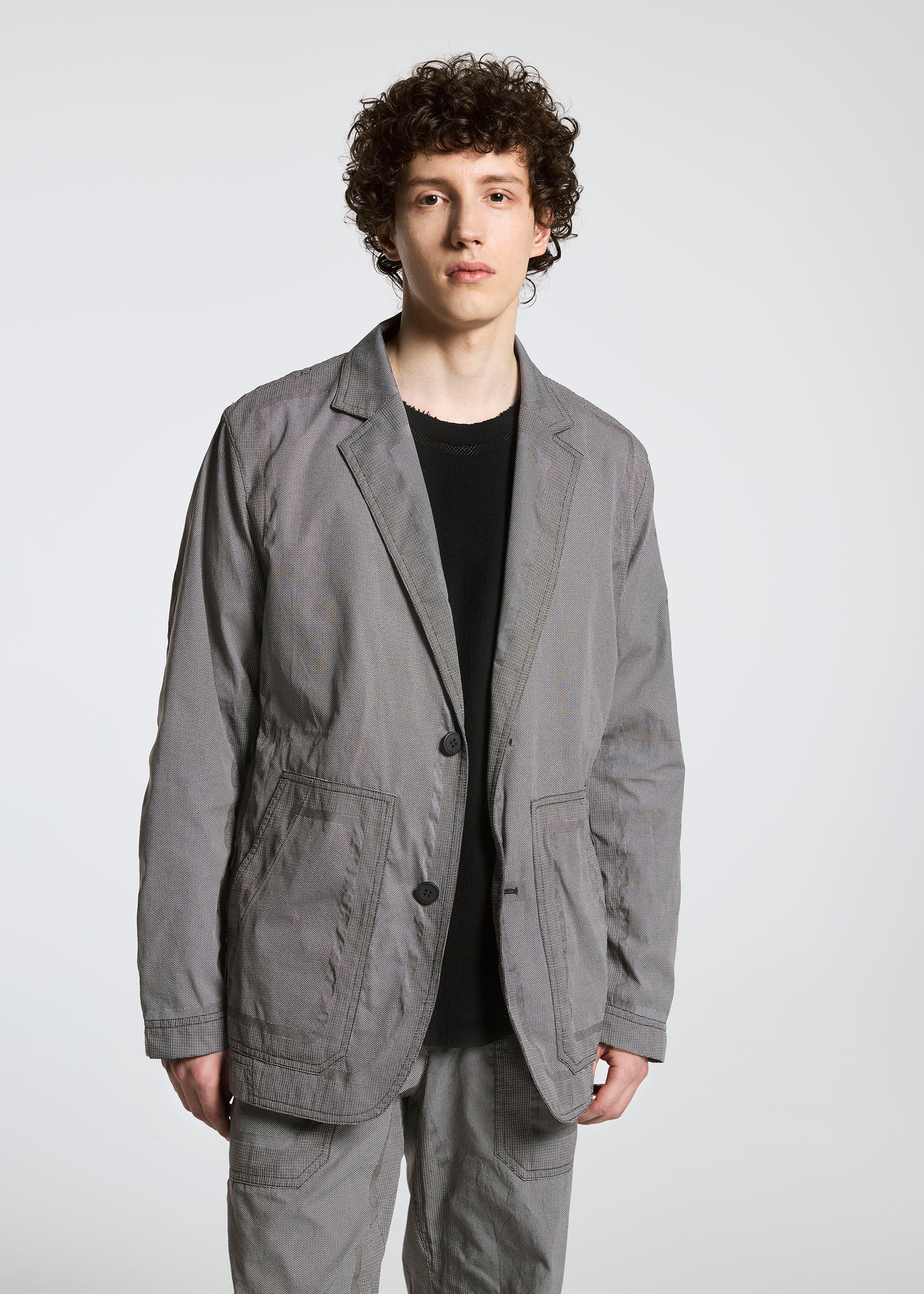 A model wears the A-POC ABLE ISSEY MIYAKE TYPE U 001 jacket.