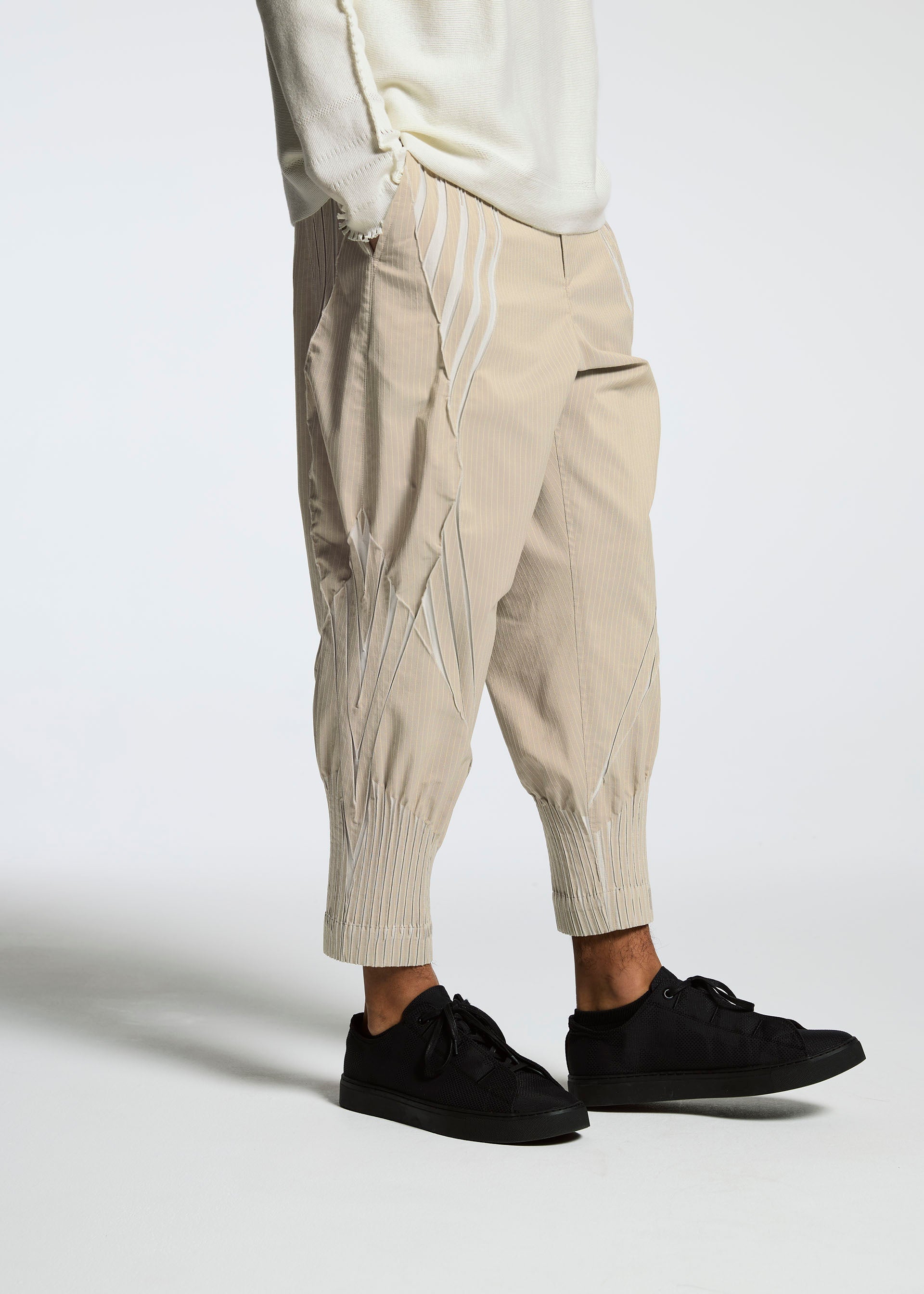 A model wears the A-POC ABLE ISSEY MIYAKE TYPE S 001 3 trousers.