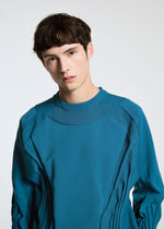 A model wears the A-POC ABLE ISSEY MIYAKE TYPE K 001 top.
