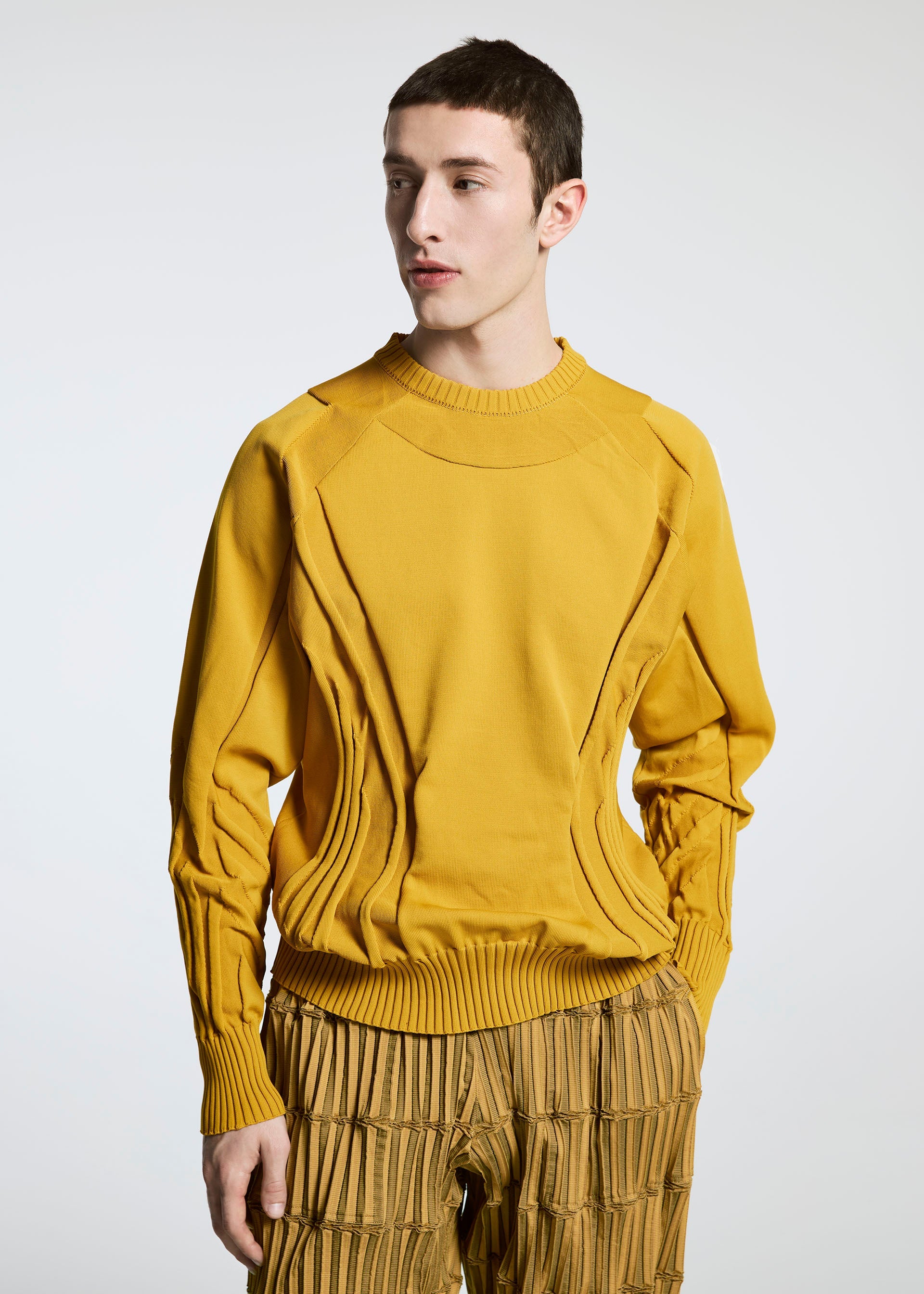 A model wears the A-POC ABLE ISSEY MIYAKE TYPE K 001 top.