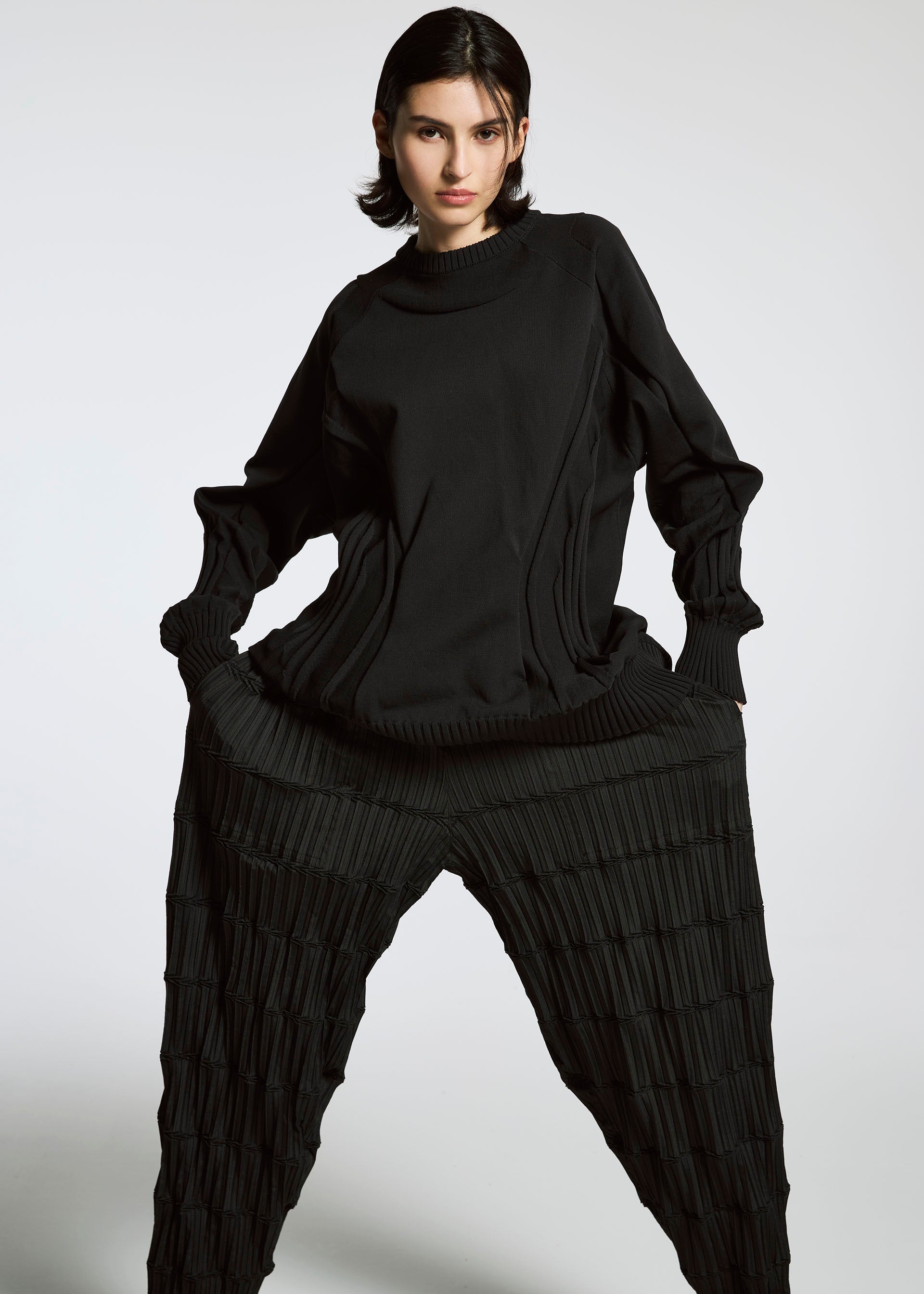 A model wears the A-POC ABLE ISSEY MIYAKE TYPE K 001 top.