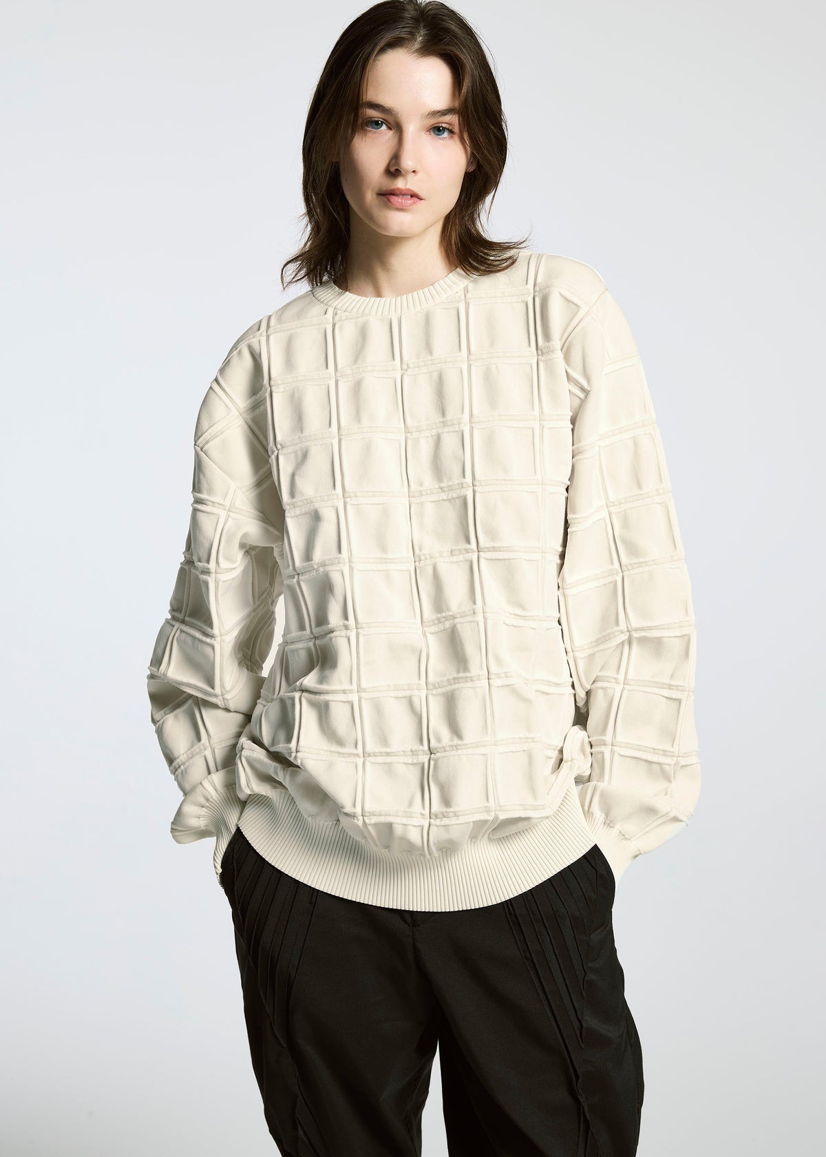 A model wears the A-POC ABLE ISSEY MIYAKE TYPE K 006 top.