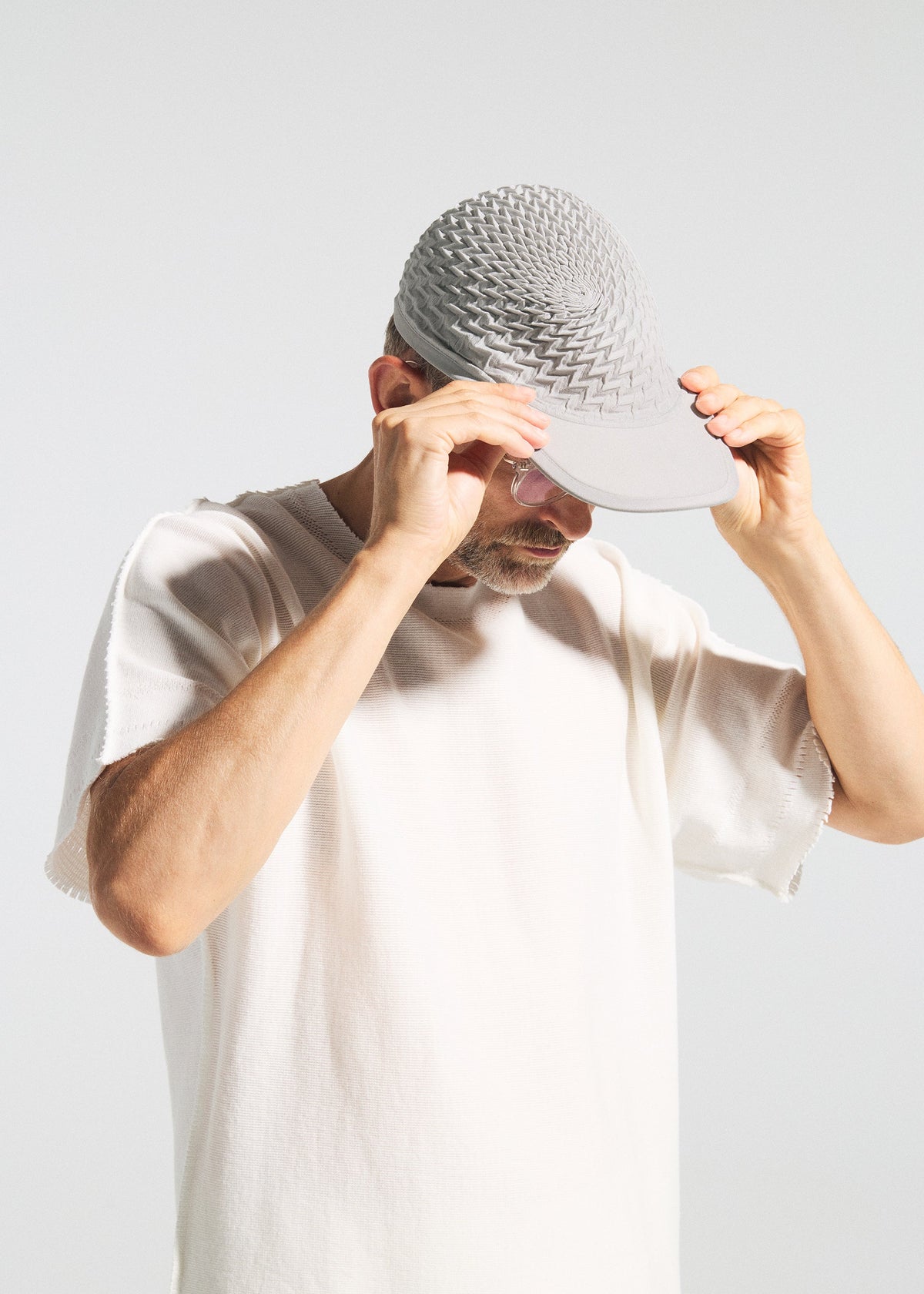 A model wears the A-POC ABLE ISSEY MIYAKE TYPE O CAP cap.