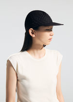 A model wears the A-POC ABLE ISSEY MIYAKE TYPE O CAP cap.