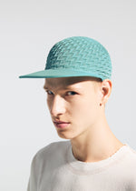 A model wears the A-POC ABLE ISSEY MIYAKE TYPE O CAP cap.