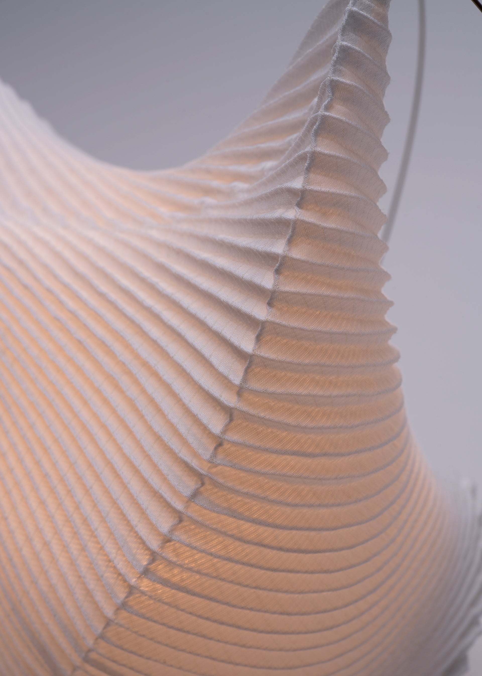 A detail shot of the A-POC ABLE ISSEY MIYAKE TYPE XIII Atelier Oï project accessory.