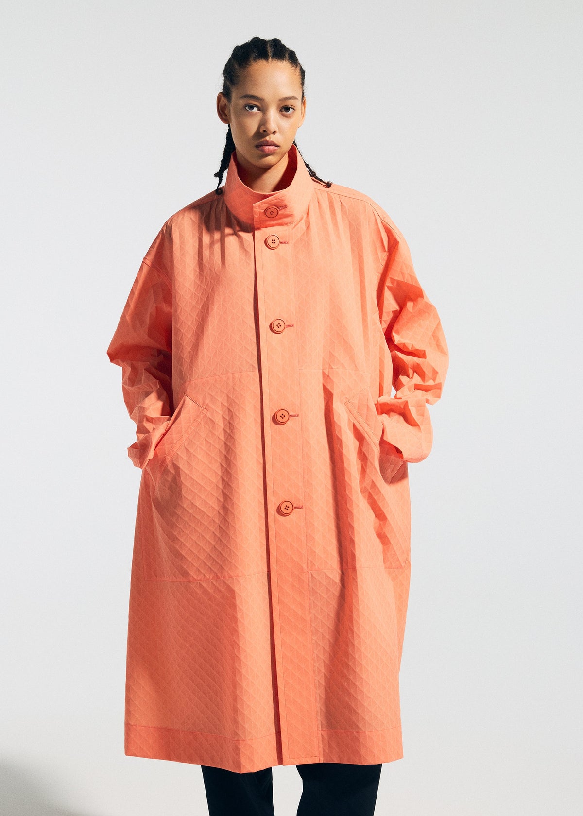 A model wears the A-POC ABLE ISSEY MIYAKE TYPE T 001 1 coat.