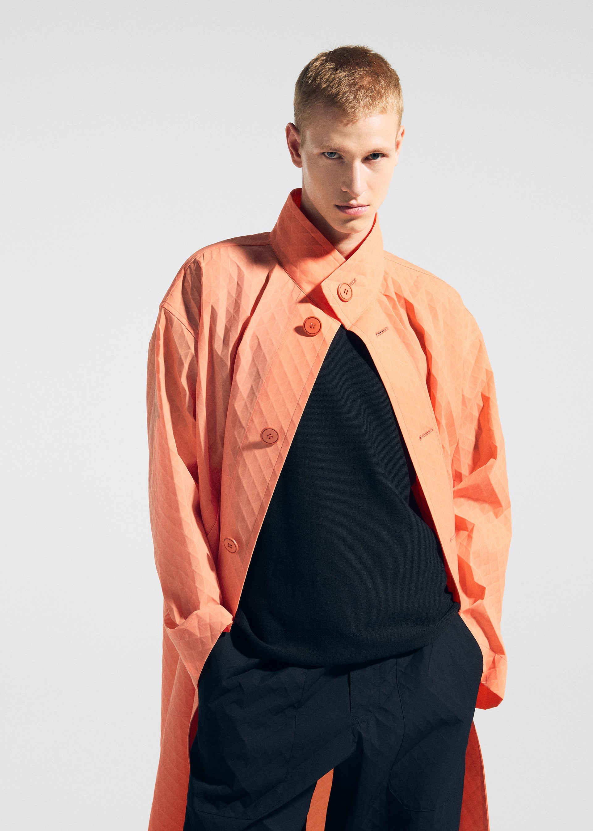 A model wears the A-POC ABLE ISSEY MIYAKE TYPE T 001 1 coat.