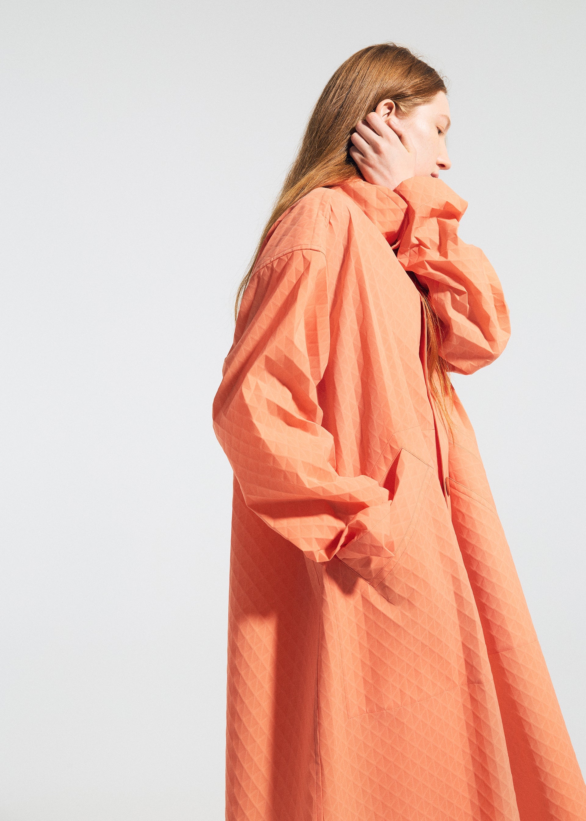 A model wears the A-POC ABLE ISSEY MIYAKE TYPE T 001 1 coat.
