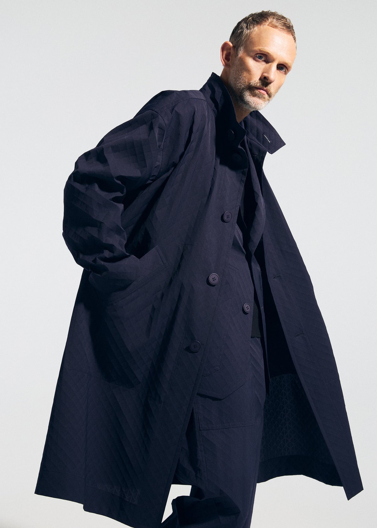A model wears the A-POC ABLE ISSEY MIYAKE TYPE T 001 1 coat.