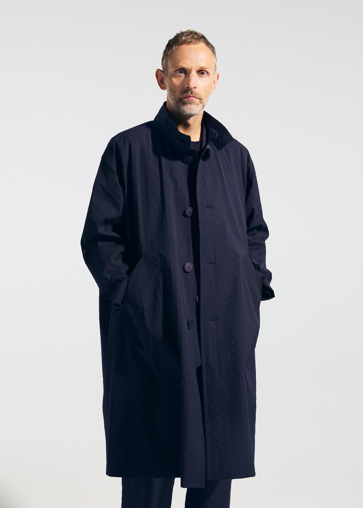 A model wears the A-POC ABLE ISSEY MIYAKE TYPE T 001 1 coat.