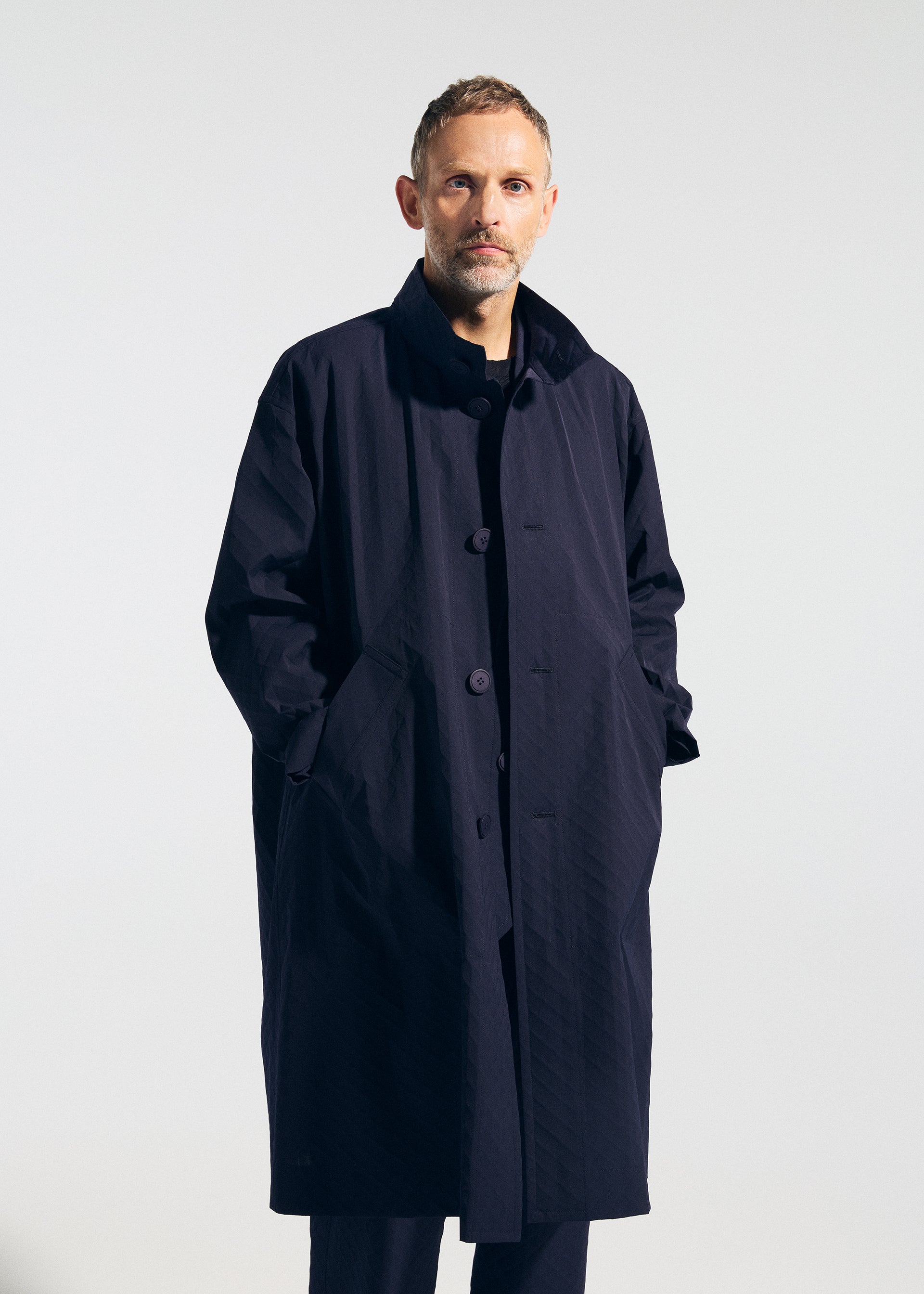 A model wears the A-POC ABLE ISSEY MIYAKE TYPE T 001 1 coat.