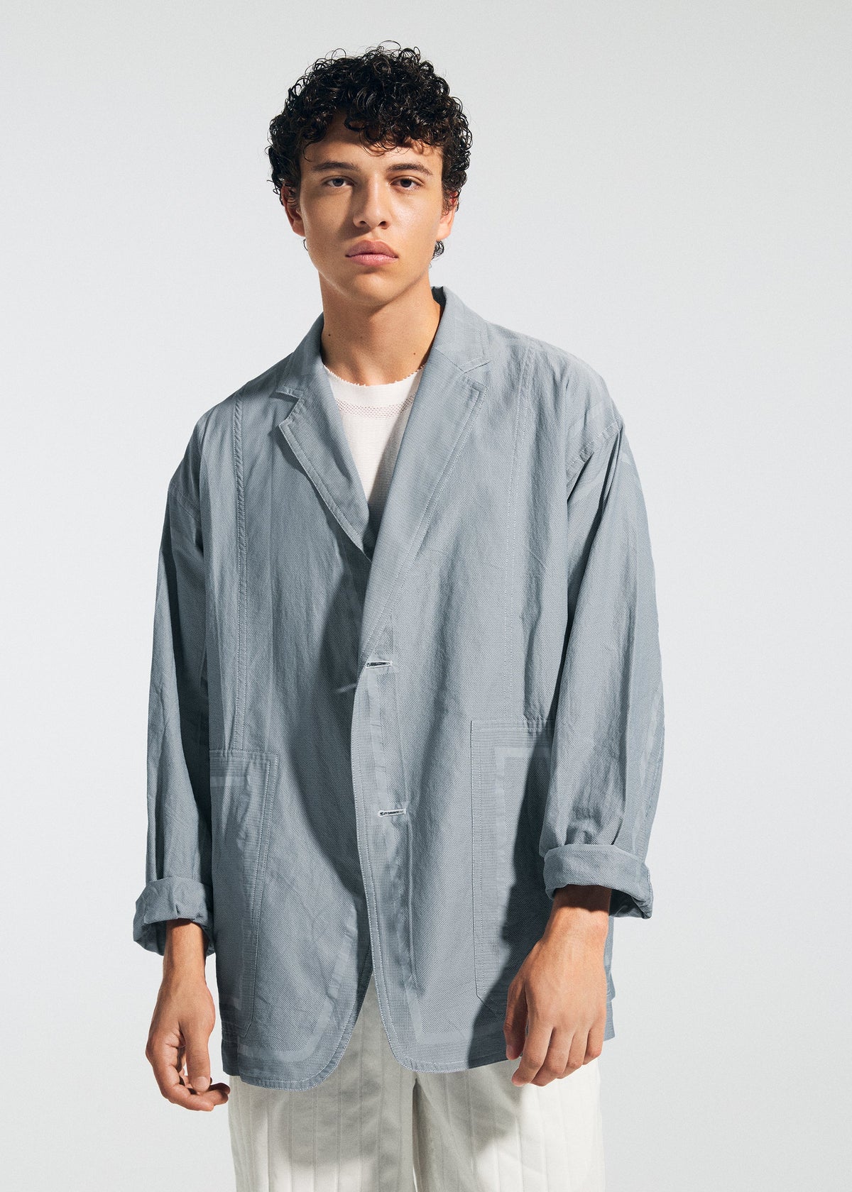 A model wears the A-POC ABLE ISSEY MIYAKE TYPE U 002 jacket.