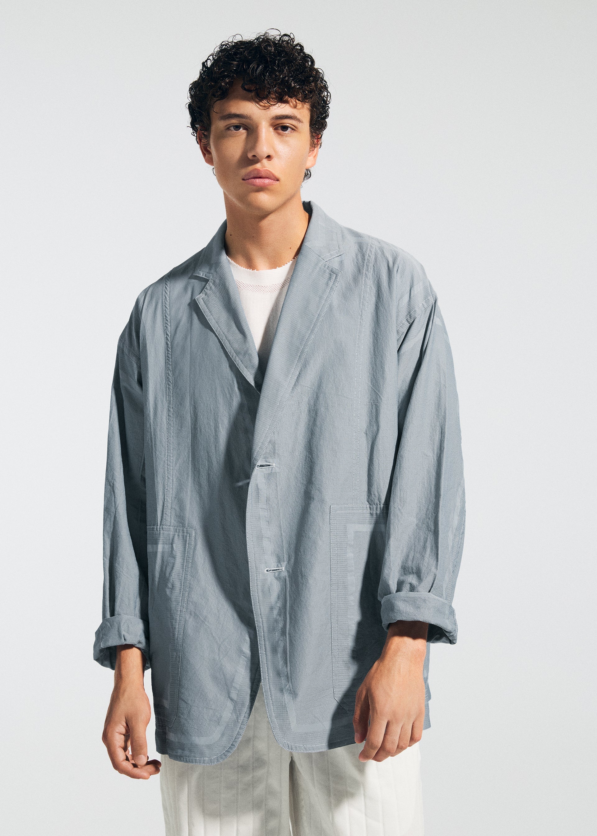 A model wears the A-POC ABLE ISSEY MIYAKE TYPE U 002 jacket.