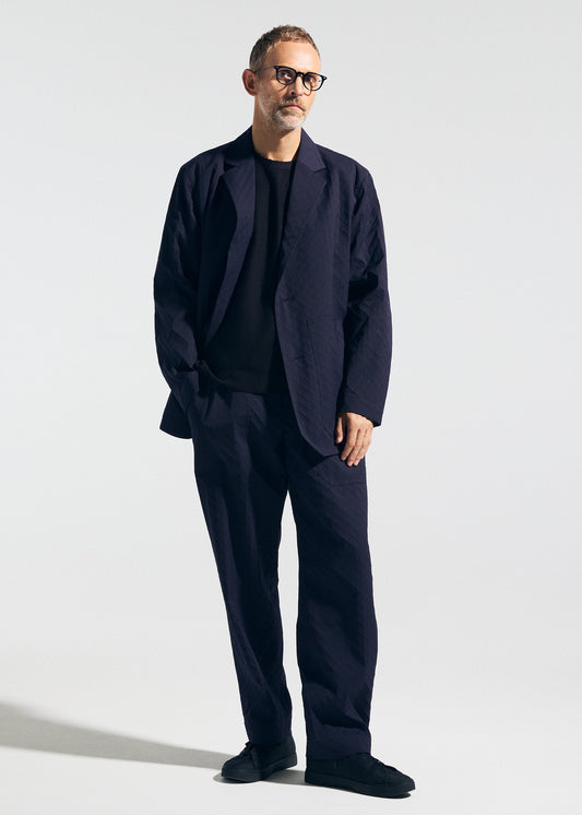 A model wears the A-POC ABLE ISSEY MIYAKE TYPE T 001 2 trousers.