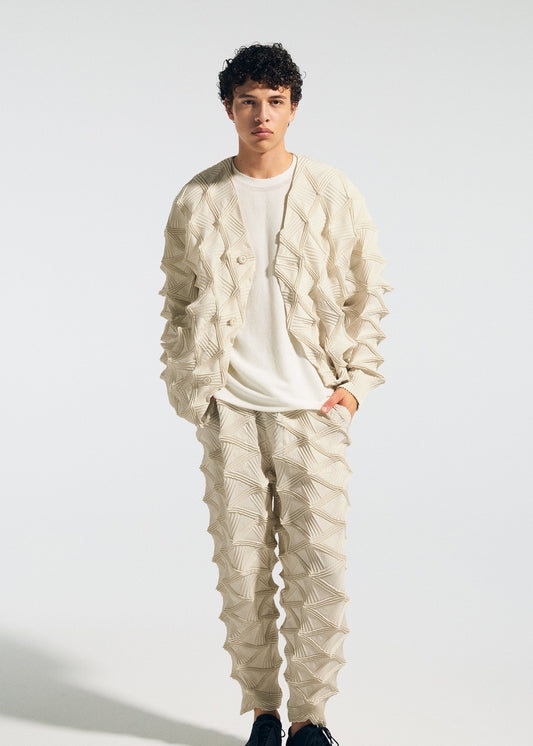 A model wears the A-POC ABLE ISSEY MIYAKE TYPE-O 023 type-o-023-trousers-ivory-hued.
