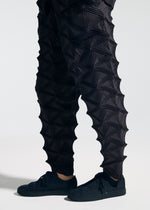 A model wears the A-POC ABLE ISSEY MIYAKE TYPE-O 023 type-o-023-trousers-ivory-hued.