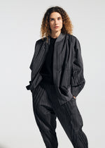 A model wears the A-POC ABLE ISSEY MIYAKE TYPE S 001 1 trousers.