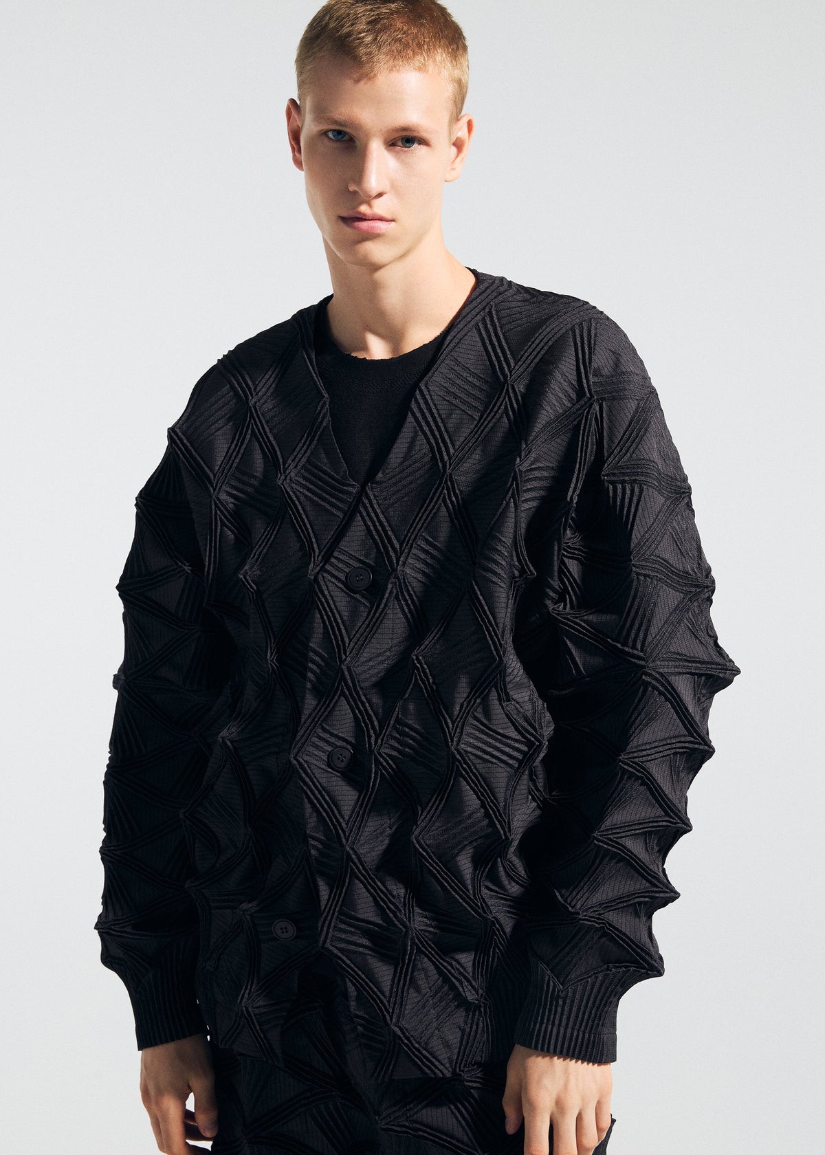 A model wears the A-POC ABLE ISSEY MIYAKE TYPE-O 023 type-o-023-cardigan-ivory-hued.