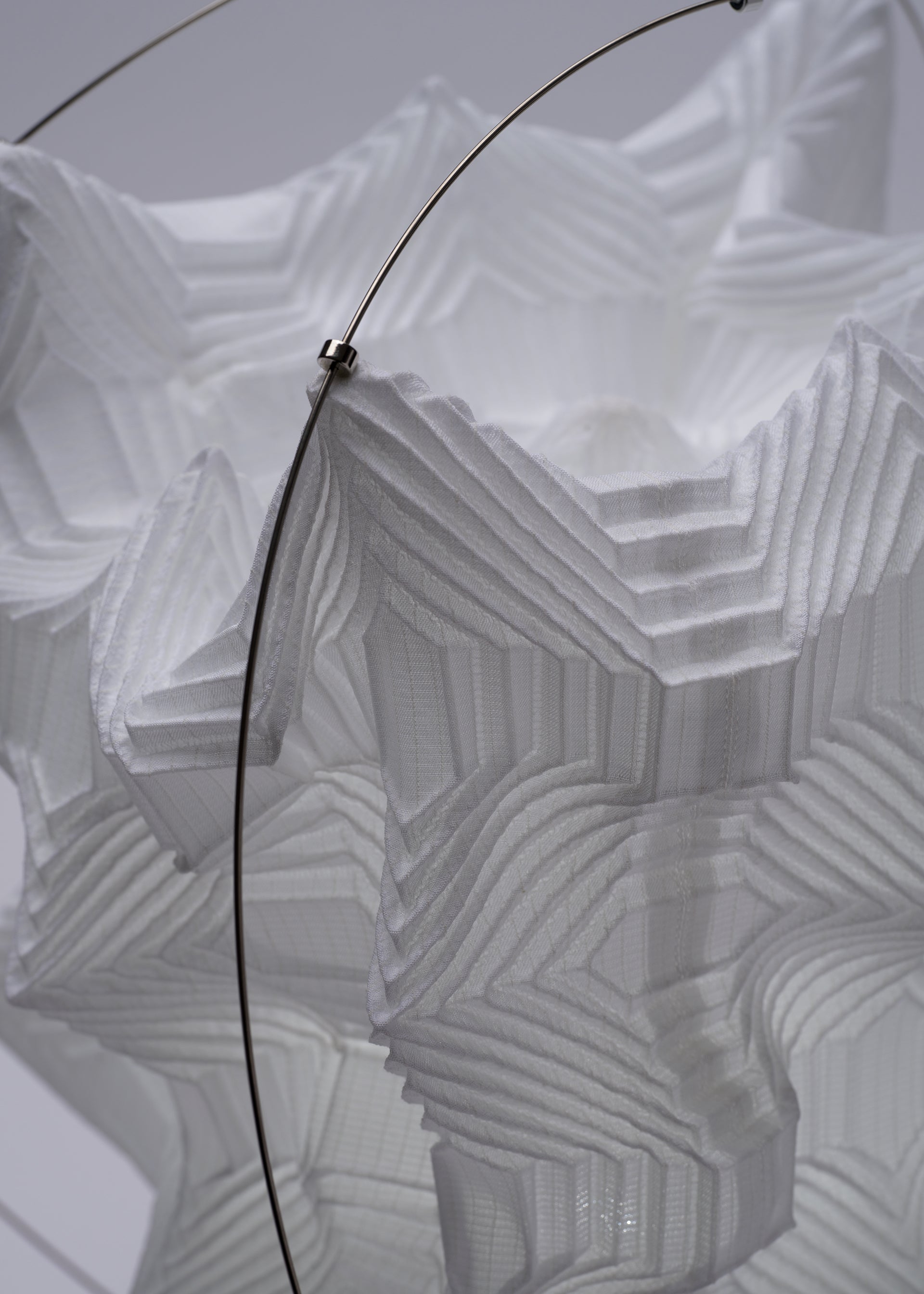 A detail shot of the A-POC ABLE ISSEY MIYAKE TYPE XIII Atelier Oï project lamp.
