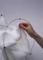 A detail shot of the A-POC ABLE ISSEY MIYAKE TYPE XIII Atelier Oï project lamp.